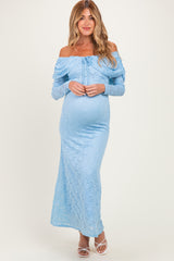 woman wearing a light blue off-shoulder lace maternity dress with a baby bump