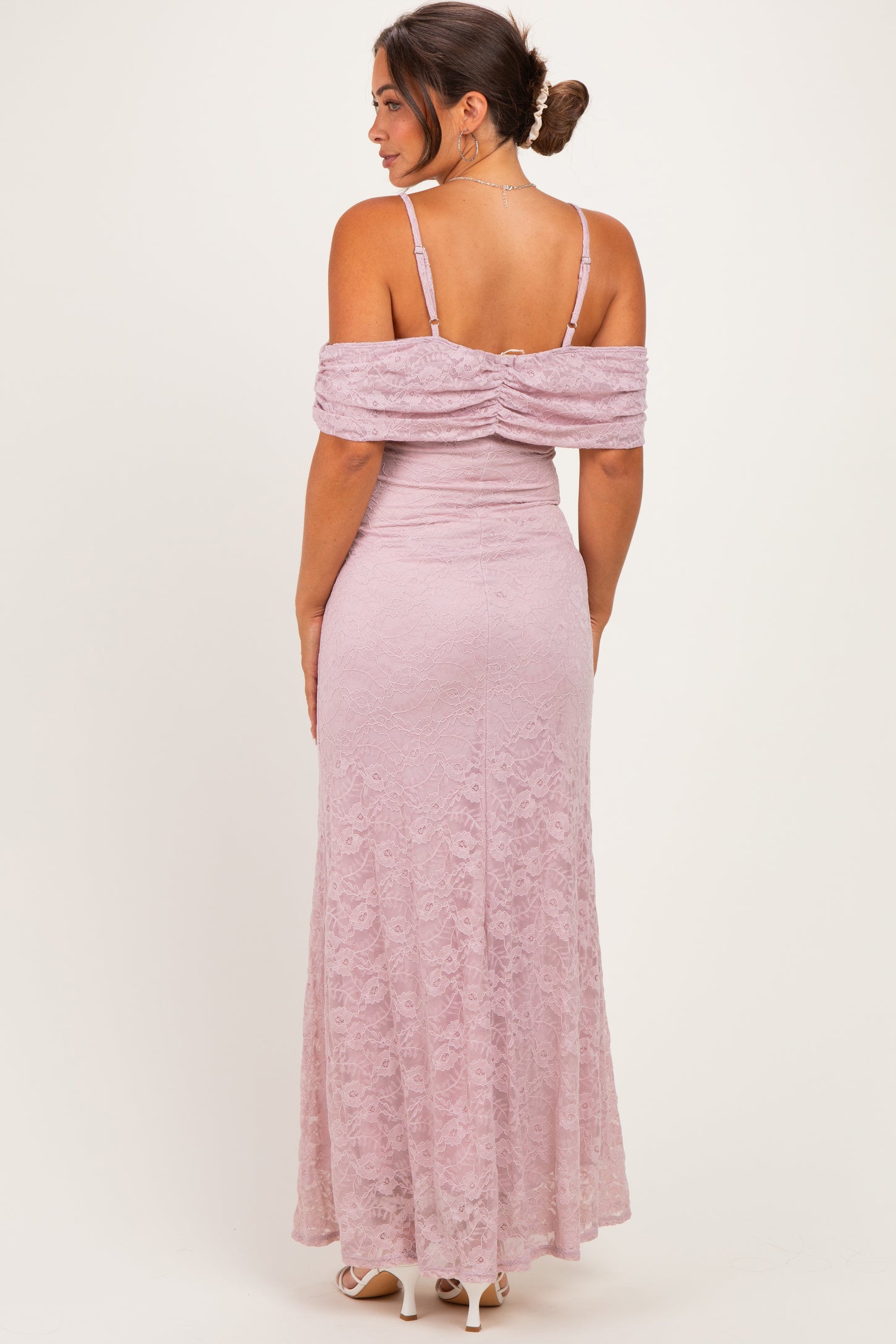 woman wearing a lavender lace maternity dress with off-the-shoulder sleeves and a fitted silhouette, showing a baby bump from the back