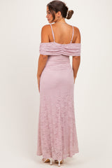 woman wearing a lavender lace maternity dress with off-the-shoulder sleeves and a fitted silhouette, showing a baby bump from the back