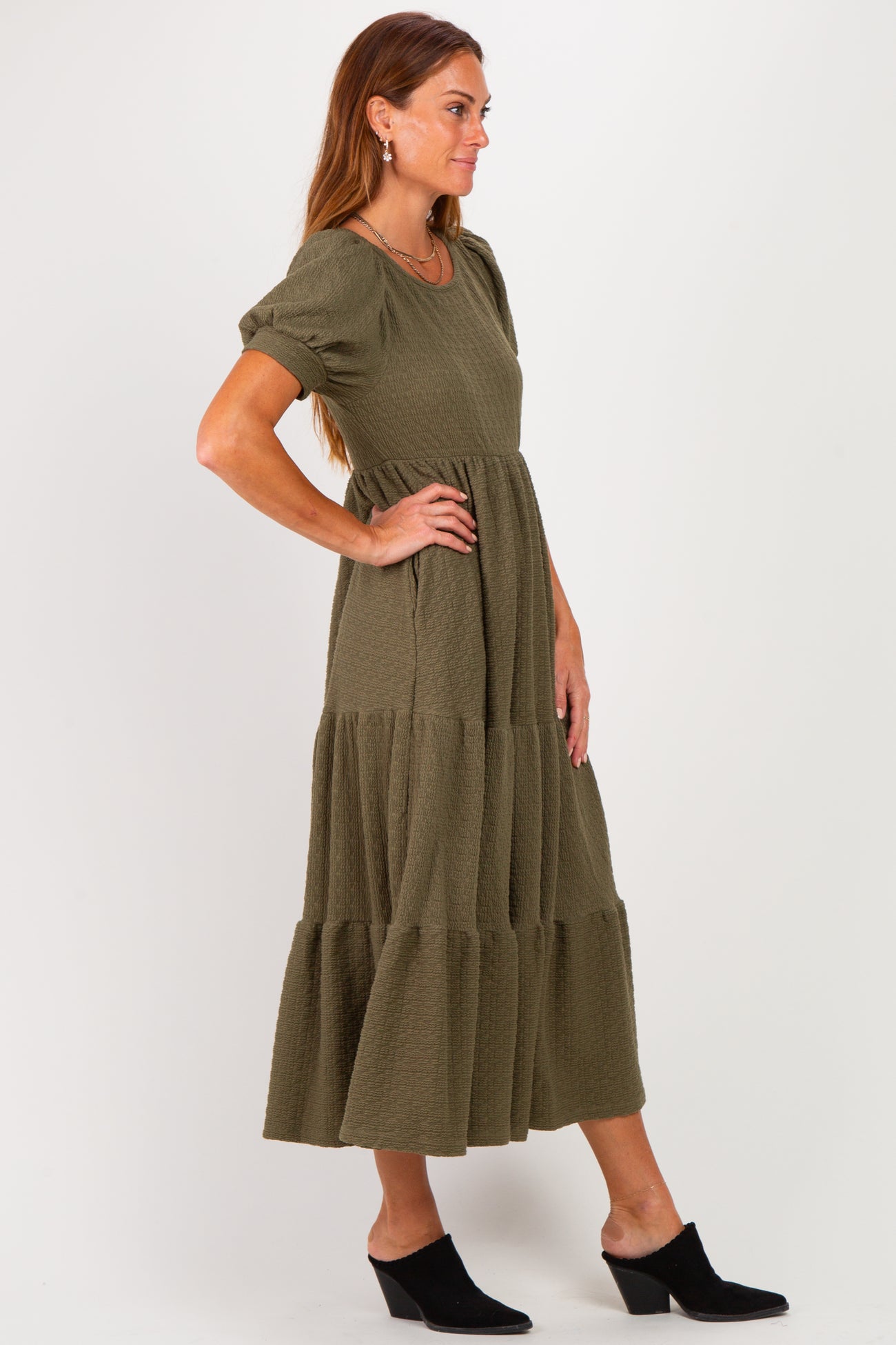 woman wearing an olive green tiered maxi dress with short sleeves and a relaxed fit