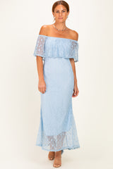 woman wearing a light blue off-the-shoulder lace maxi dress with a flowy skirt and fitted bodice