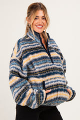 woman wearing a striped fleece maternity pullover with a quarter zip and front pockets, holding her baby bump