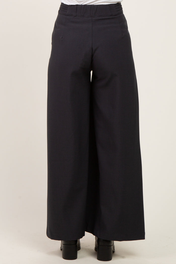 maternity wear navy wide-leg trousers shown from the back