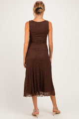 woman wearing a brown lace maternity dress, styled with a fitted bodice and flared skirt, seen from the back
