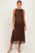 woman wearing a brown lace midi maternity dress showcasing her baby bump