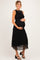 woman wearing a black lace midi maternity dress and holding her baby bump