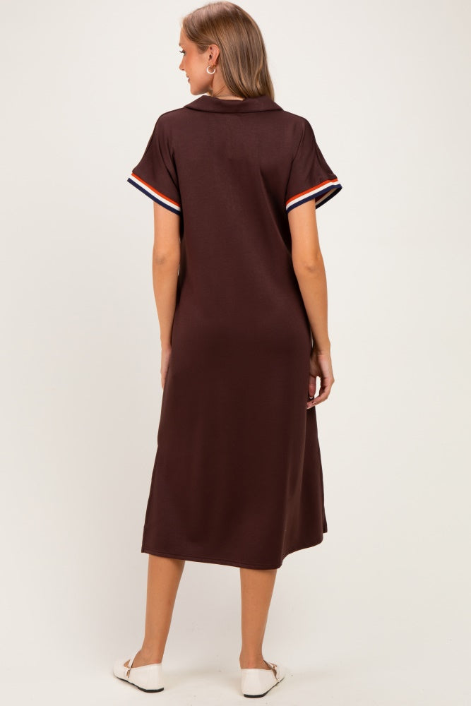 woman wearing a brown maternity polo dress with striped short sleeves, viewed from the back