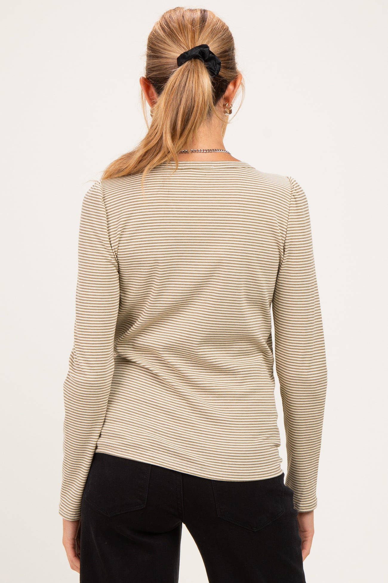 woman wearing a striped long sleeve maternity top, viewed from the back