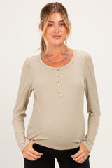 woman wearing a striped long sleeve maternity top with button detail and a visible baby bump
