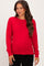 woman wearing a red maternity sweater with long sleeves and a fitted silhouette, showing her baby bump
