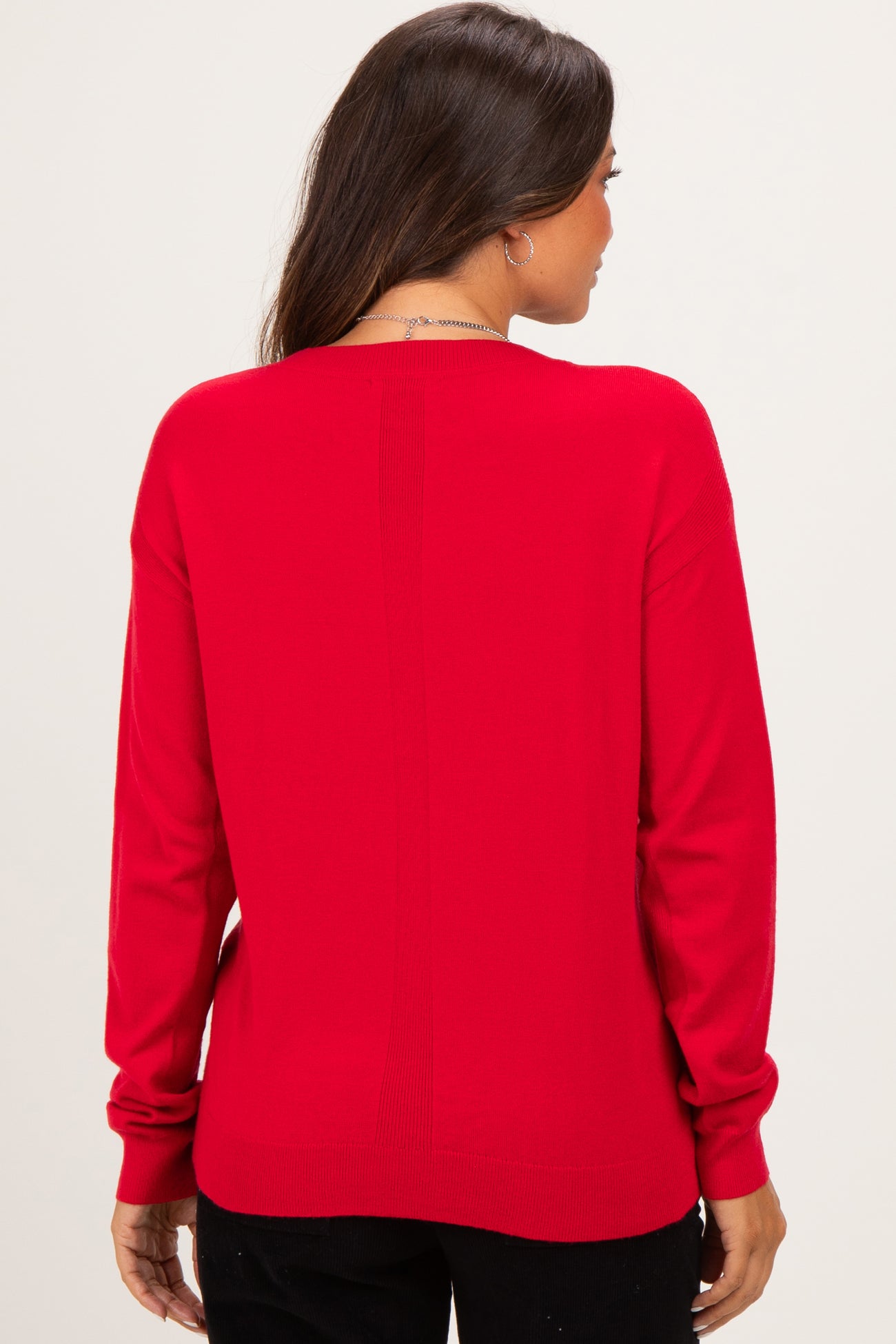 woman wearing a red maternity sweater, shown from the back with a relaxed fit and long sleeves