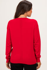 woman wearing a red maternity sweater, shown from the back with a relaxed fit and long sleeves