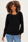 woman wearing a black long sleeve maternity sweater paired with light blue jeans