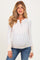 woman wearing a floral long sleeve maternity top with button details and a visible baby bump