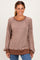 woman wearing a brown striped long sleeve pullover sweatshirt with a relaxed fit and crew neckline