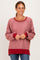 woman wearing a red and white striped long sleeve pullover sweater with a relaxed fit and ribbed cuffs