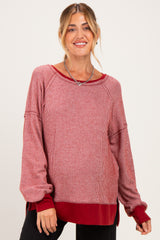 woman wearing a red and white striped long sleeve maternity top with a relaxed fit and side slits