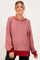 woman wearing a red and white striped long sleeve maternity top with a relaxed fit and side slits