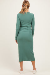 woman wearing a green ribbed maternity dress with long sleeves, shown from the back