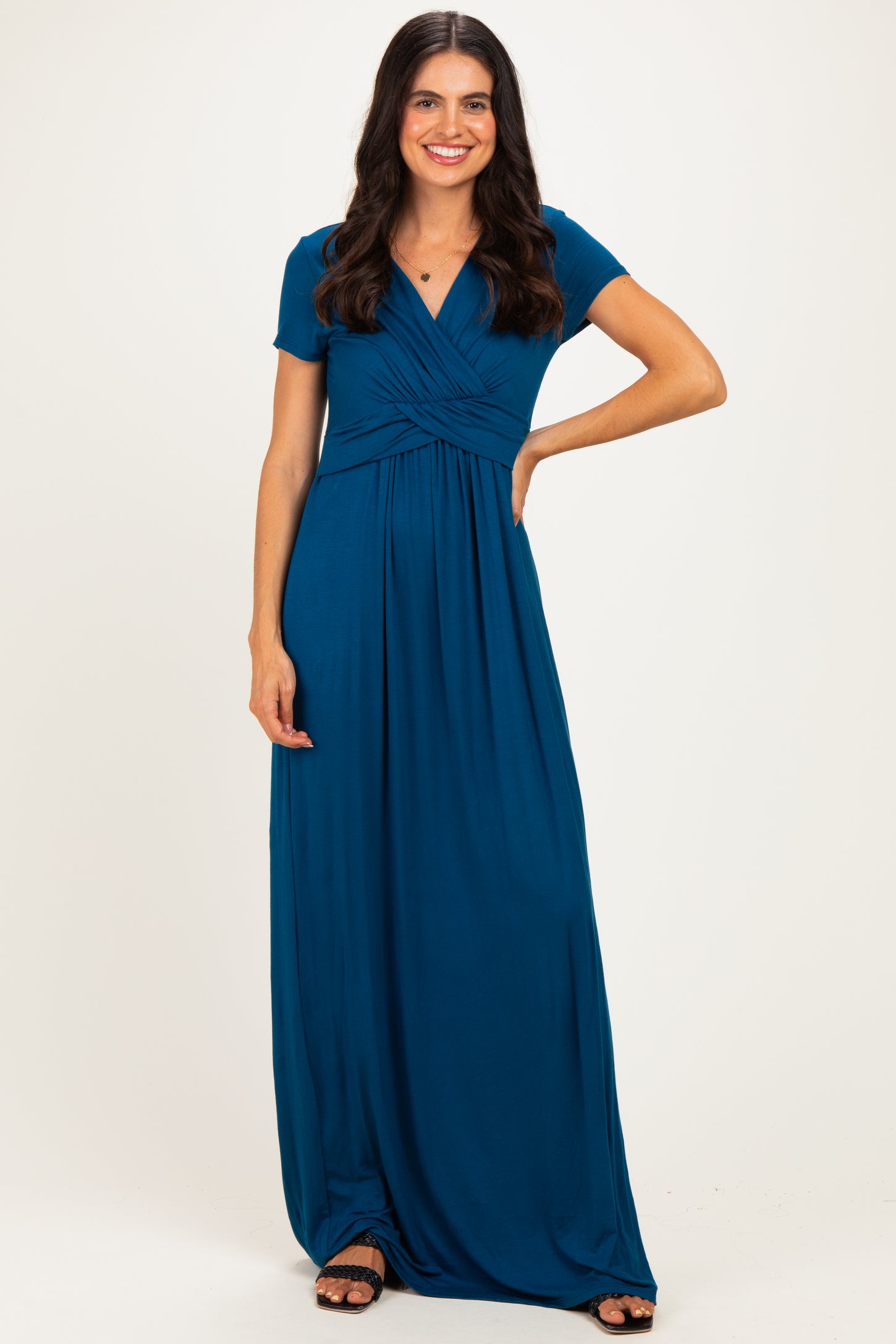 woman wearing a teal short sleeve maxi dress with a twisted front detail and a relaxed fit