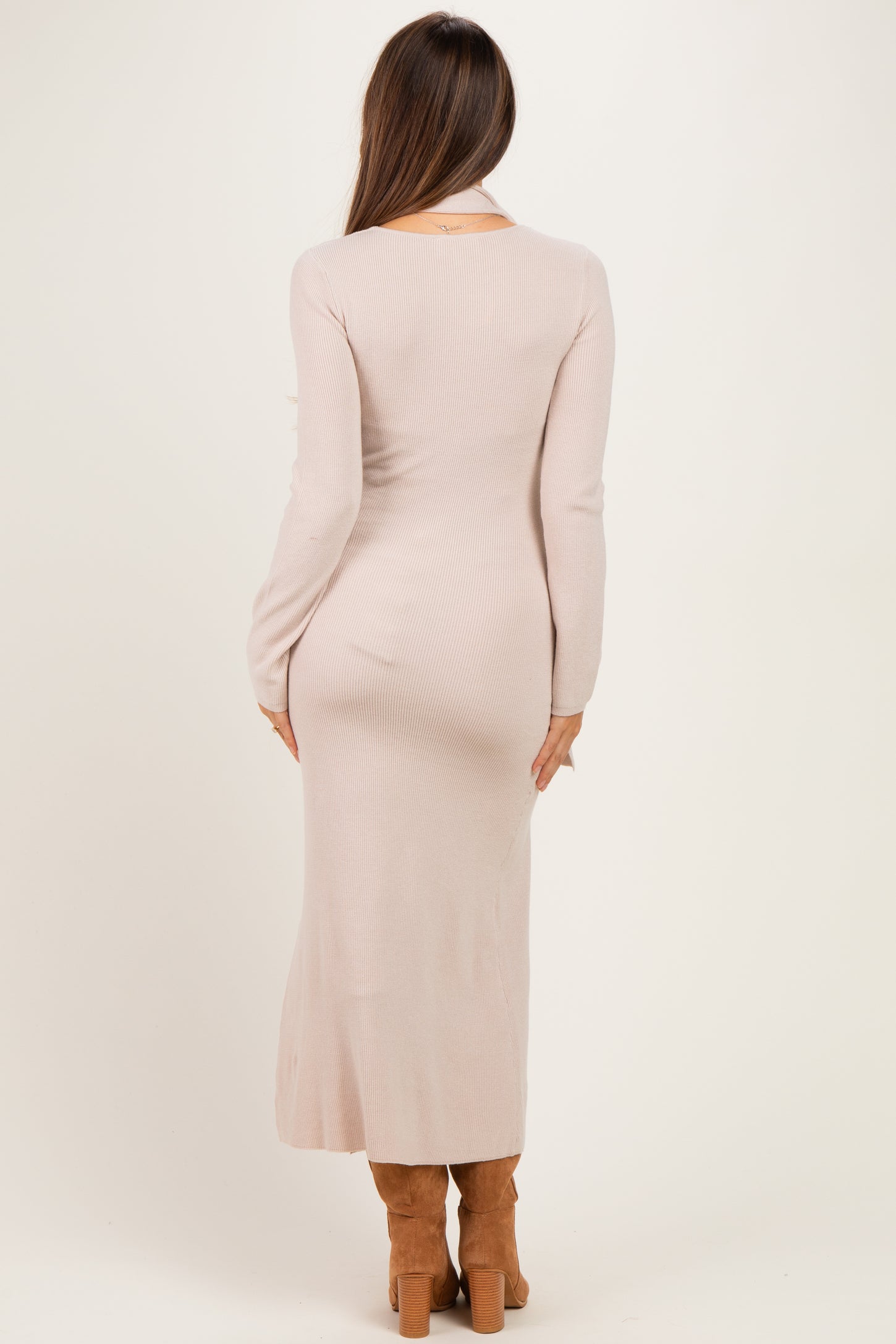woman wearing a long sleeve ribbed blush pink maternity dress, back view