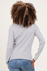 woman wearing a striped maternity long sleeve top with a fitted style and a baby bump visible from the back