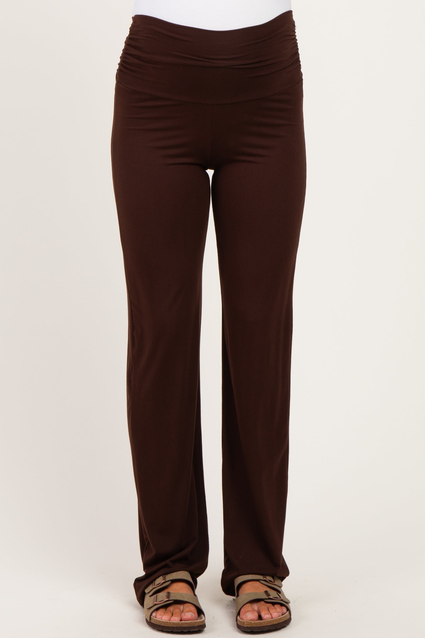 woman wearing dark brown maternity pants with a flattering ruched waistband and relaxed fit