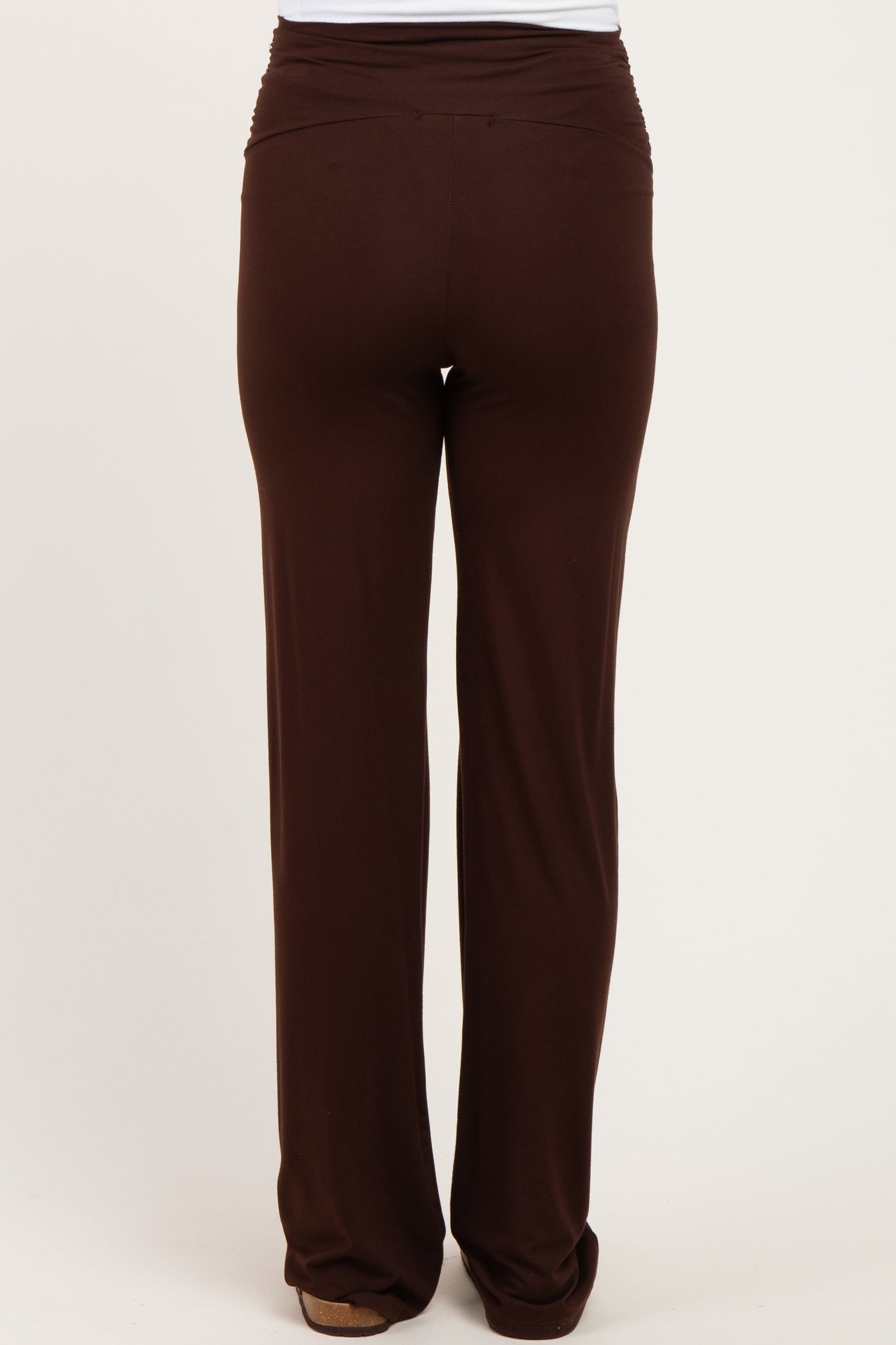 maternity wear brown stretchy pants with a ruched waistband, viewed from the back