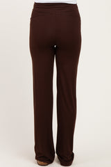 maternity wear brown stretchy pants with a ruched waistband, viewed from the back