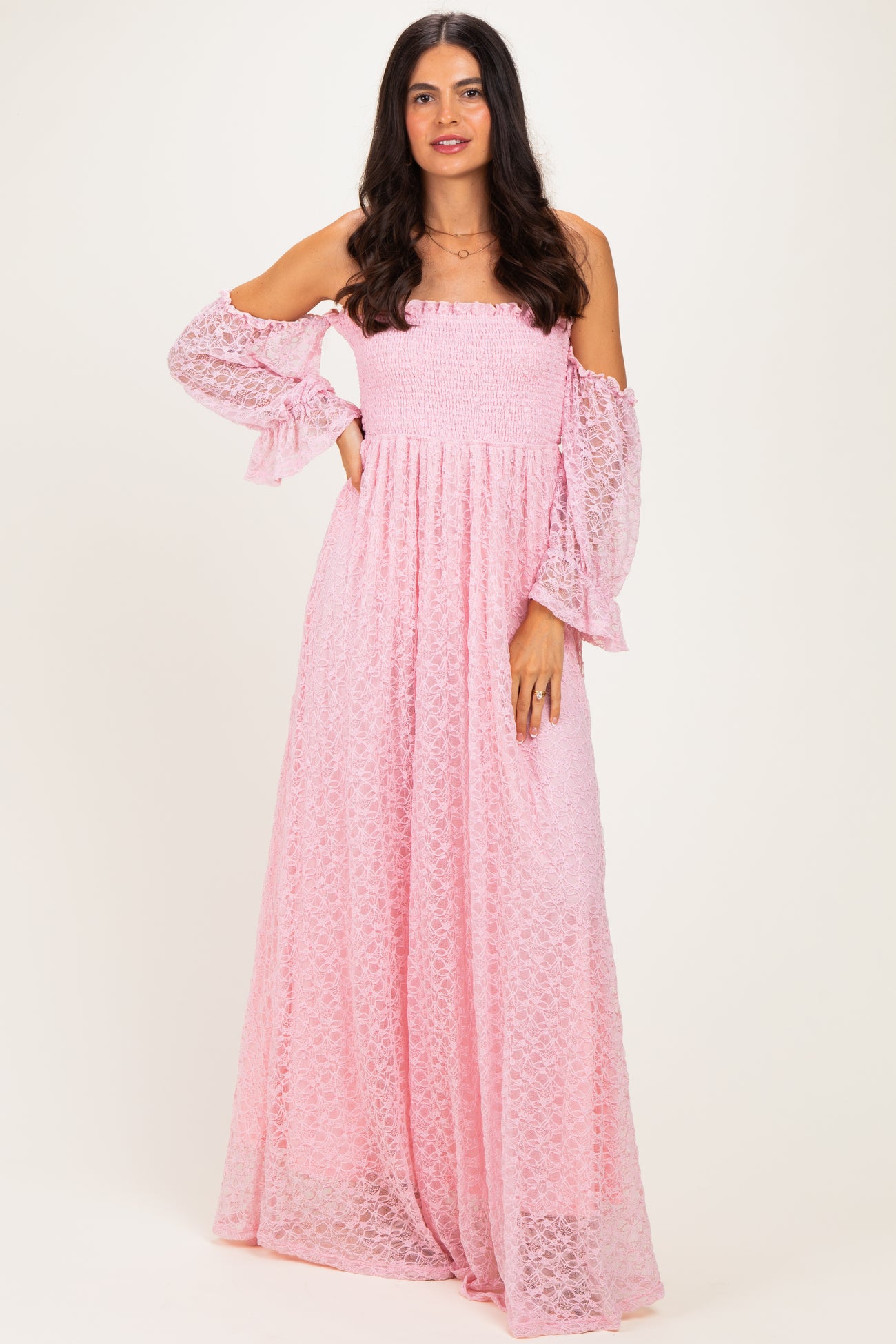 woman wearing a pink off-shoulder maxi dress with smocked bodice and bell sleeves