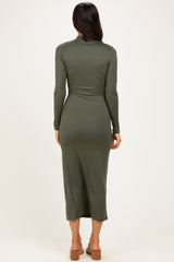 woman wearing a dark green long sleeve maxi dress with a fitted silhouette and a midi length