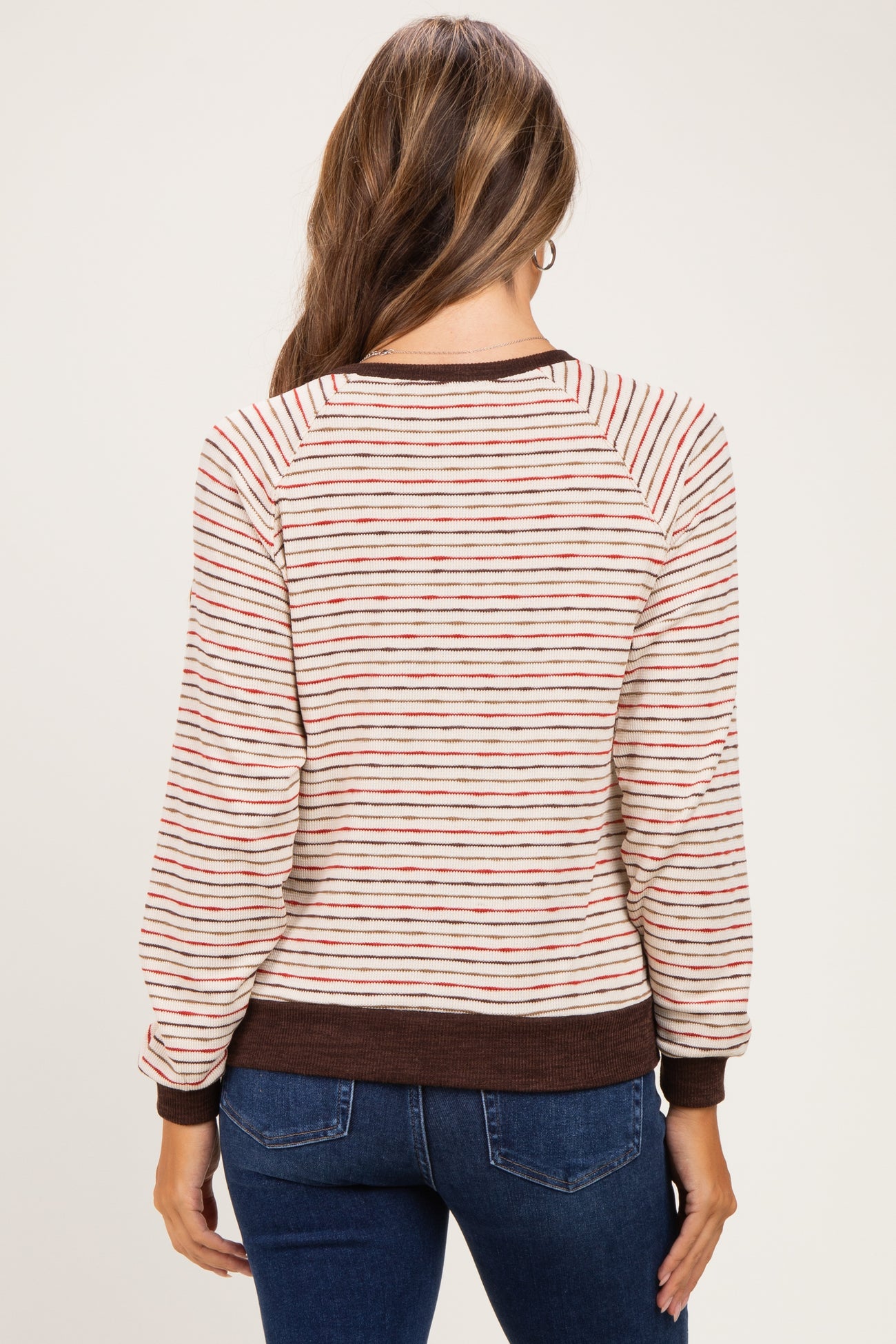 woman wearing a striped maternity sweater with a relaxed fit and long sleeves, seen from the back