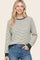 woman wearing a cream and green striped long sleeve sweatshirt with a relaxed fit and ribbed cuffs
