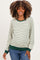 woman wearing a cream and green striped maternity sweatshirt with long sleeves and a relaxed fit