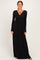 woman wearing a black long sleeve maxi dress with a wrap-style bodice and gathered waist detail