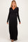 woman wearing a black long sleeve maternity maxi dress with a twisted front detail and a visible baby bump
