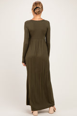 woman wearing an olive green long sleeve maternity maxi dress, back view, with a fitted bodice and flowing skirt