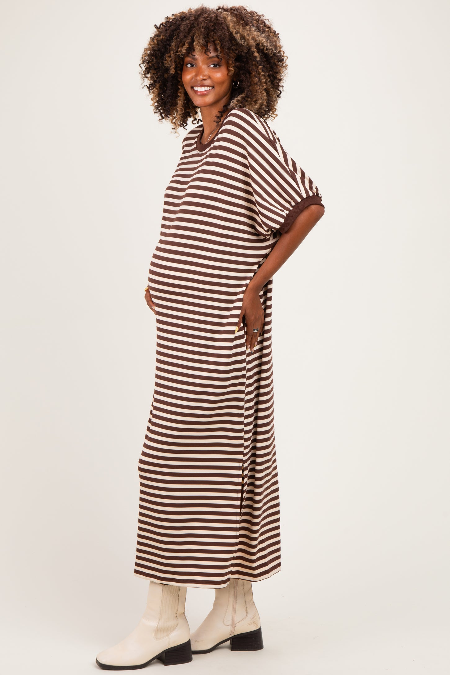 woman wearing a brown and white striped maternity dress with a relaxed fit and a visible baby bump