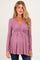 woman wearing a mauve long sleeve maternity top with a cross-over v-neck and empire waist, showing a baby bump