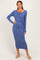 woman wearing a long sleeve blue wrap dress with a side tie detail and a fitted silhouette