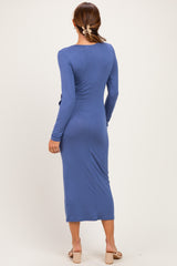 woman wearing a long sleeve blue midi dress with a fitted silhouette and a back view showcasing the design