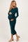 woman wearing a dark green long sleeve maternity dress with a tie at the waist and visible baby bump