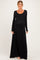 woman wearing a black long sleeve maternity maxi dress with a scoop neckline and baby bump visible