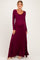 woman wearing a maroon long sleeve maternity maxi dress with a scoop neckline and visible baby bump
