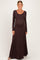 woman wearing a long sleeve brown maternity dress with a fitted bodice and flowy skirt, baby bump visible