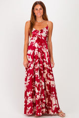 woman wearing a red and white floral maxi dress with adjustable straps and a gathered bust detail