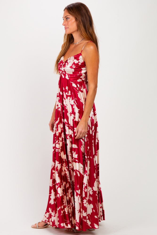woman wearing a red floral maxi dress with a ruched bodice and spaghetti straps