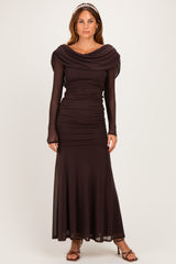 woman wearing a dark brown long sleeve ruched evening gown with a draped neckline and a flowing skirt
