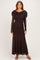 woman wearing a dark brown long sleeve ruched evening gown with a draped neckline and a flowing skirt