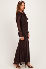 woman wearing a brown long sleeve evening gown with ruched detailing and a flowy skirt, styled with a headband